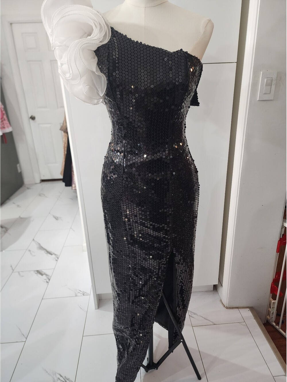 Elegant Black Sequin One-Shoulder Evening Dress with White Floral Accent